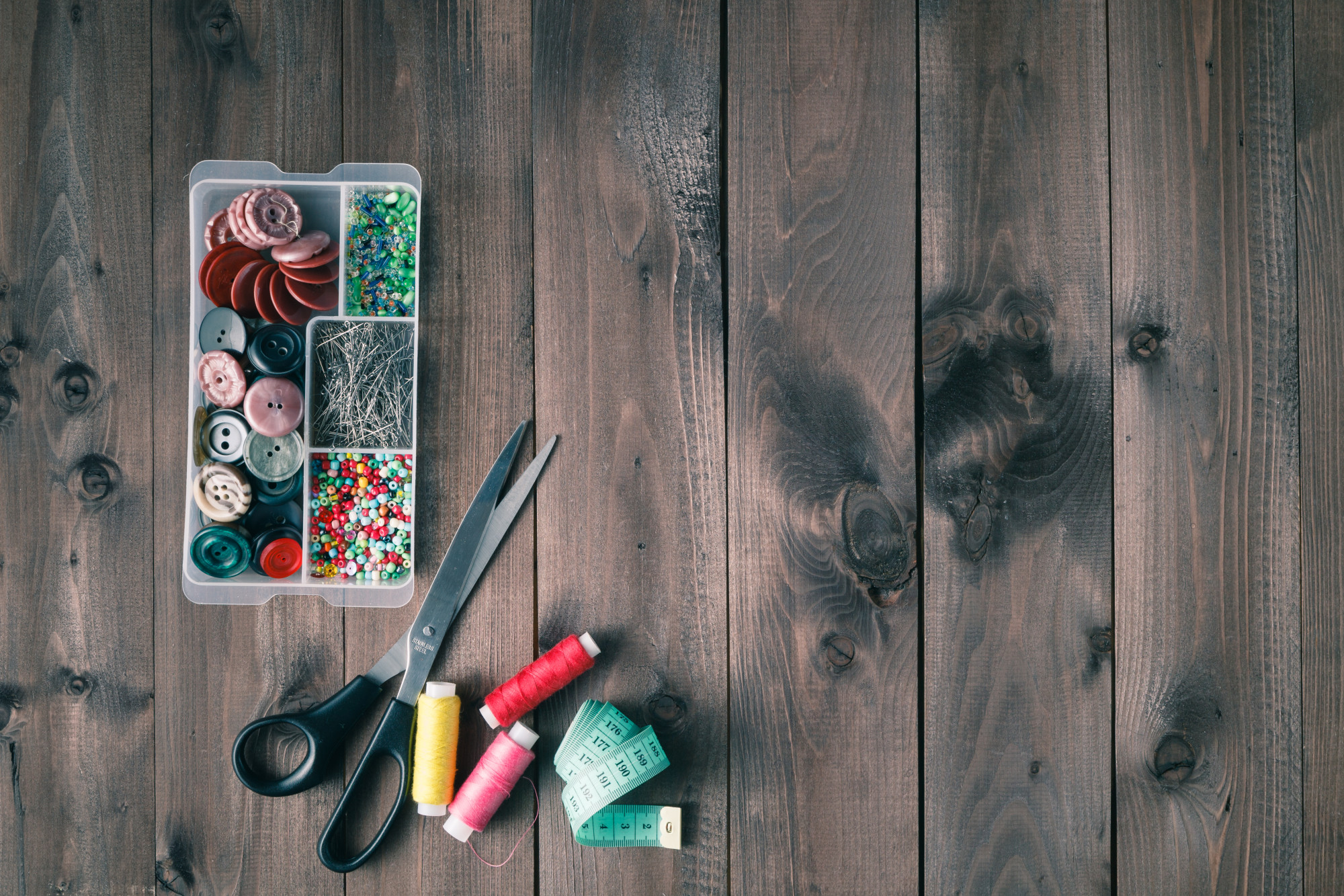 Workspace with embroidery tools and sketches on paper