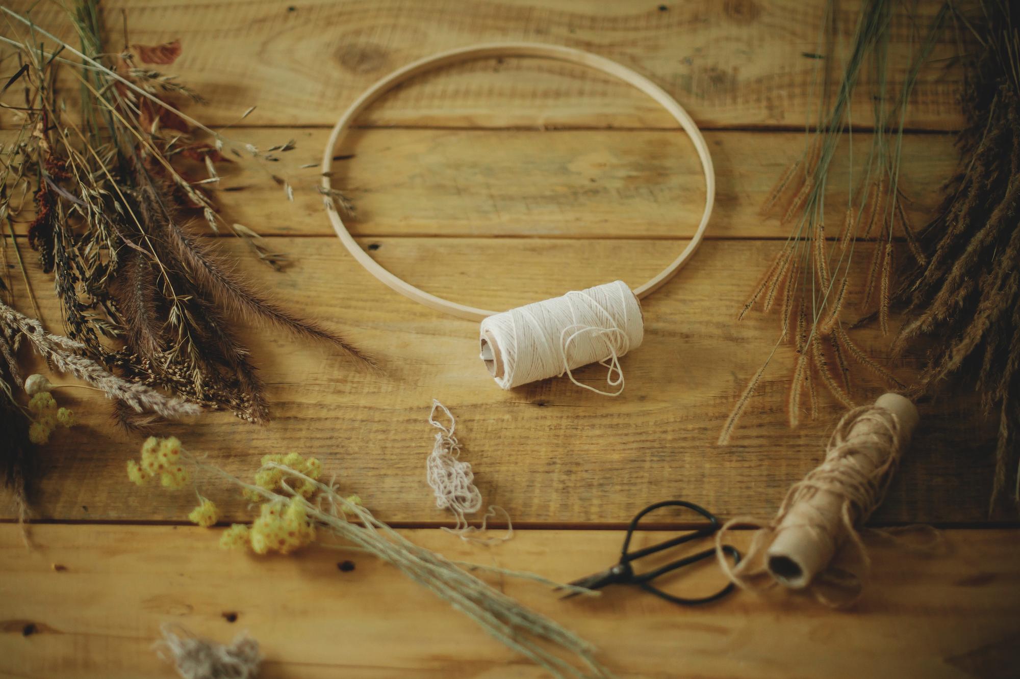 Close-up of hand embroidery hoop with earthy threads